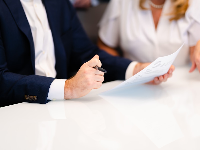 Professional signing onboarding documents in a business meeting